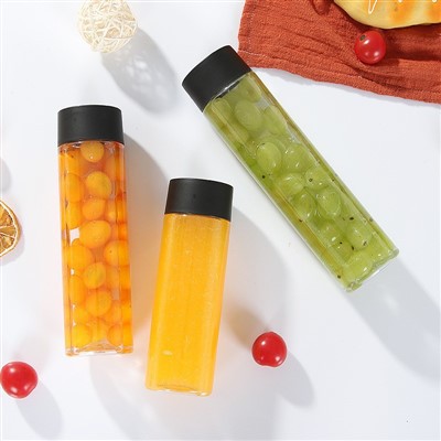 Ampolles de forma rodona per a suc de fruites amb tapa blanca negra